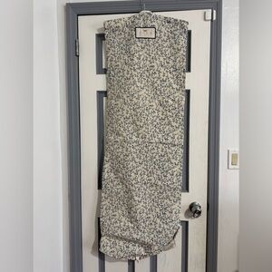 Two Agua Bendita garment bags